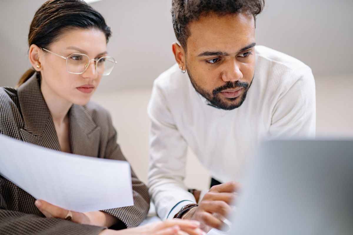 A pair reviewing records on screen