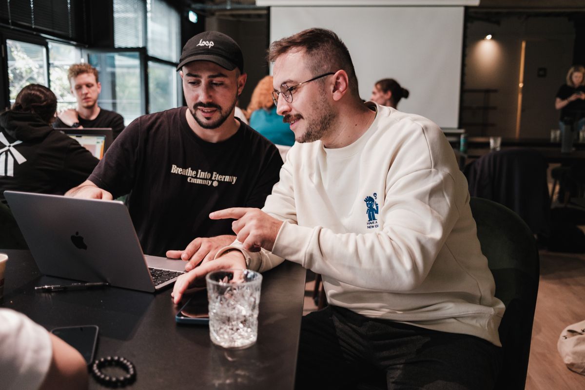 Two men looking at a laptop together